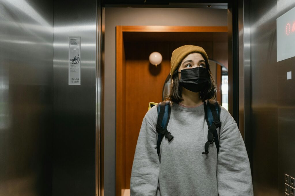 woman walking into elevator