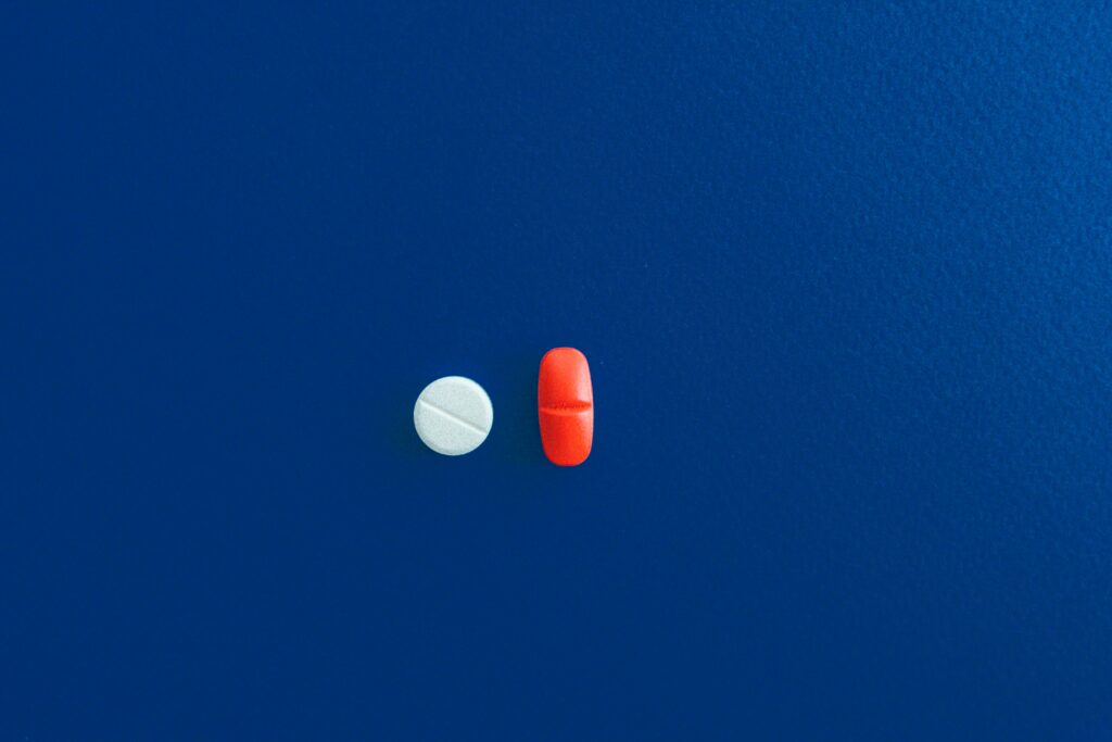 red and white pill on blue background