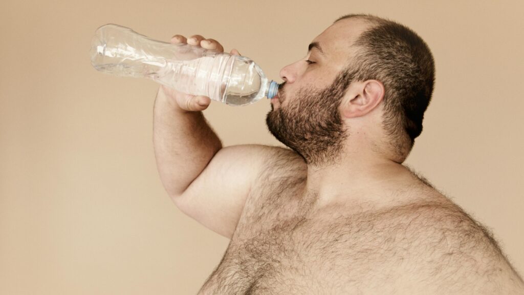 man drinking water from bottle